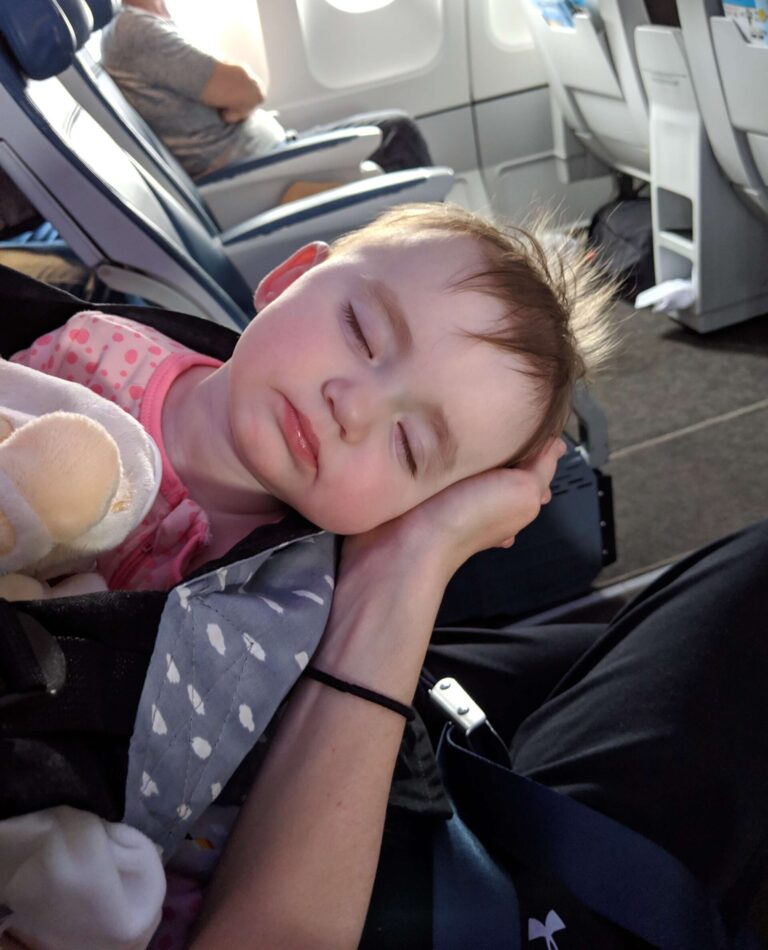 Child's first flight - Baby sleeping on the plane