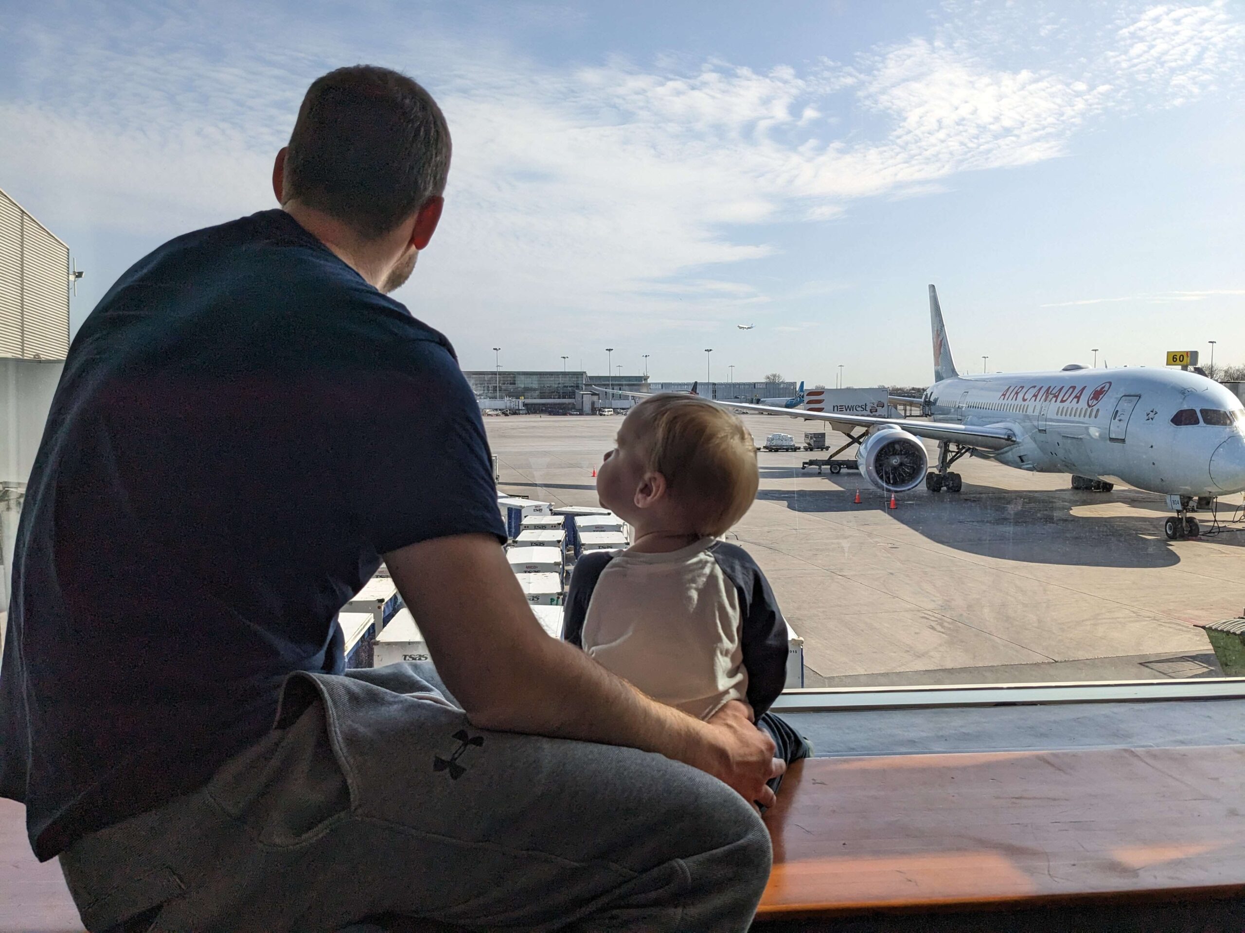 flying with kids - tips for surviving layovers with kids (looking at planes)