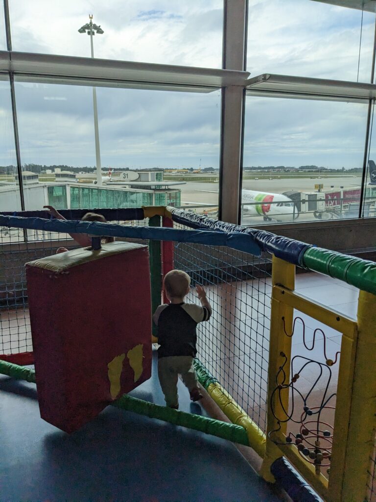 Toddler playing at the play area of Lisbon's airport.