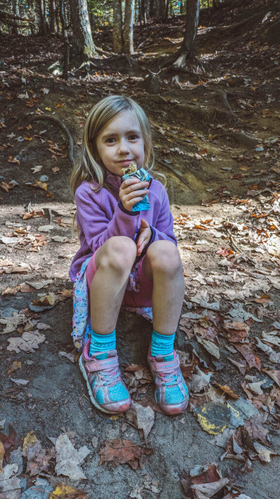 Snacks are one of the most important hiking essentials for kids - find a nice spot during your family hike for a snack break
