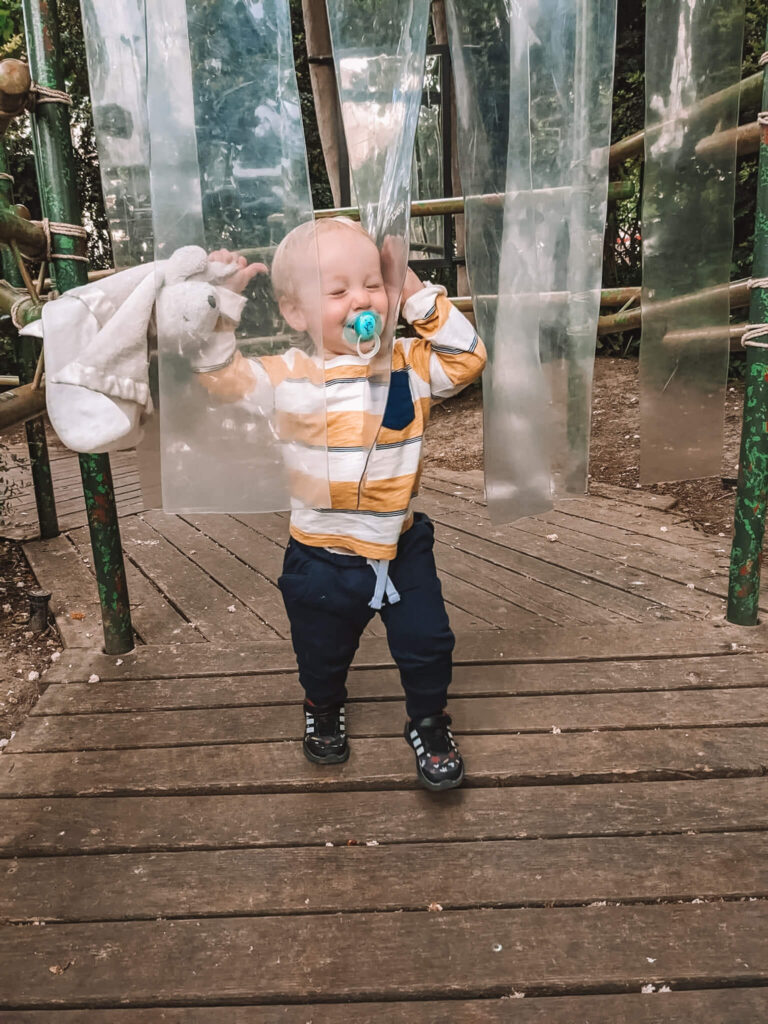A toddler having fun in one of the best playgrounds in Paris for families (pictured: Jardin Nelson Mandela playground)