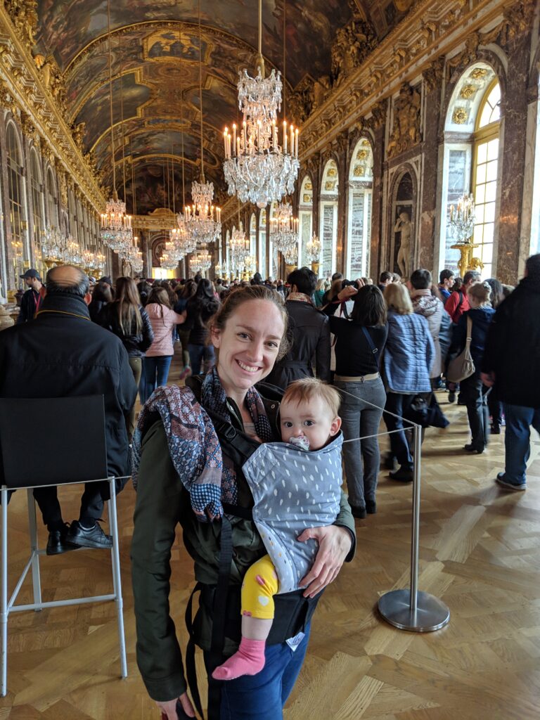 A mother and a baby at Château de Versailles - I am using my best travel baby carrier, a must when travelling with a baby