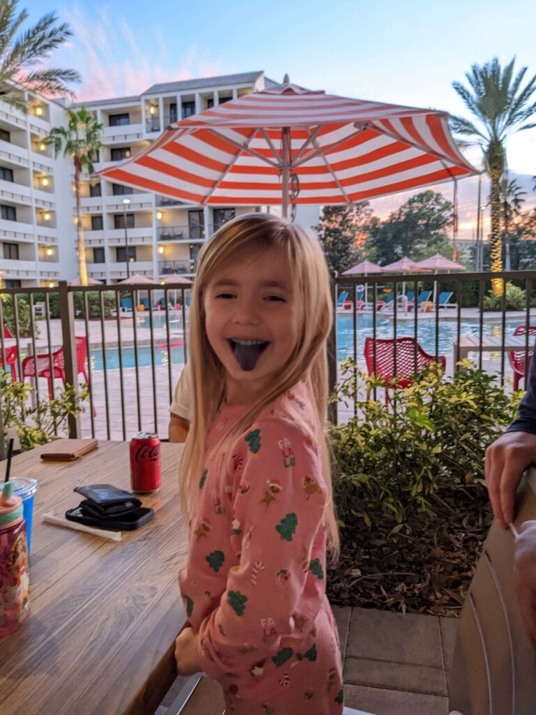 A kid enjoying a meal on the beautiful terrace of the Holiday Inn Orlando Disney Springs