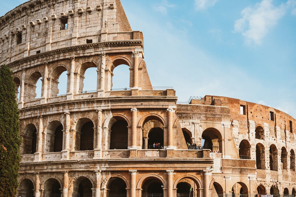 The famous Colosseum structure against a blue sky in Rome, Italy. 