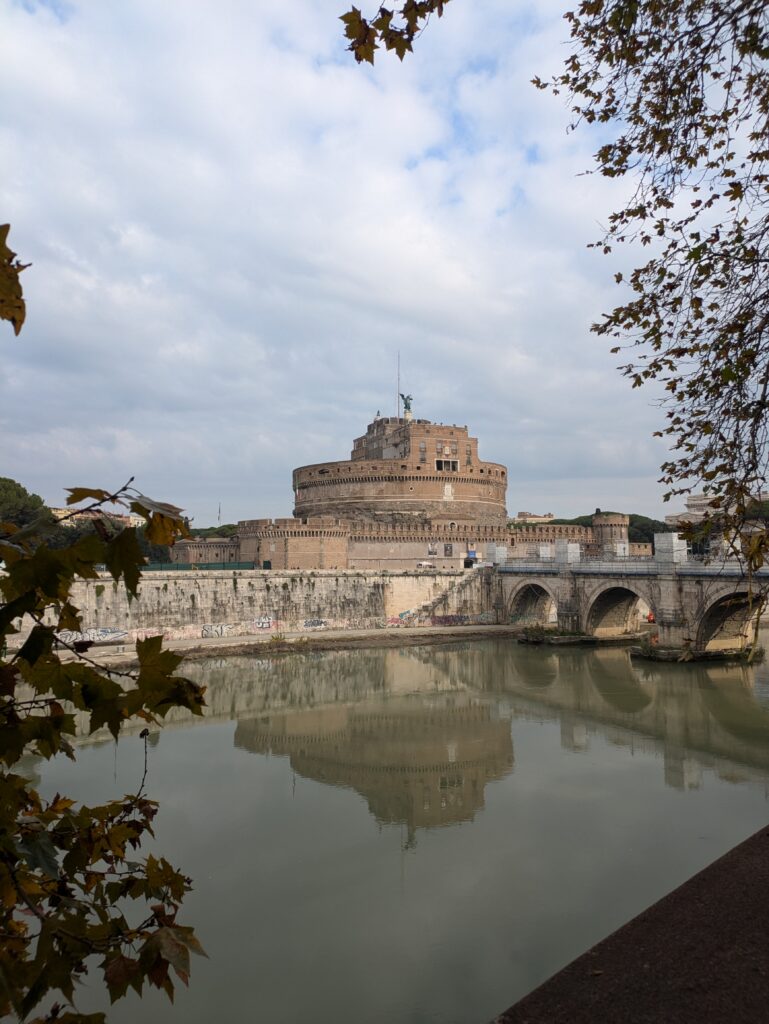 The Tiber river running in front of the Castel Sant' Angelo in Rome, Italy. The castle is one of the most underrated things to do in Rome with kids.