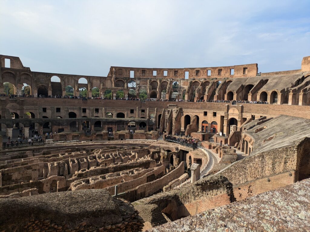 Inside of the Colosseum in Rome, Italy on a sunny day. The Colosseum is a must when visiting Rome with kids.