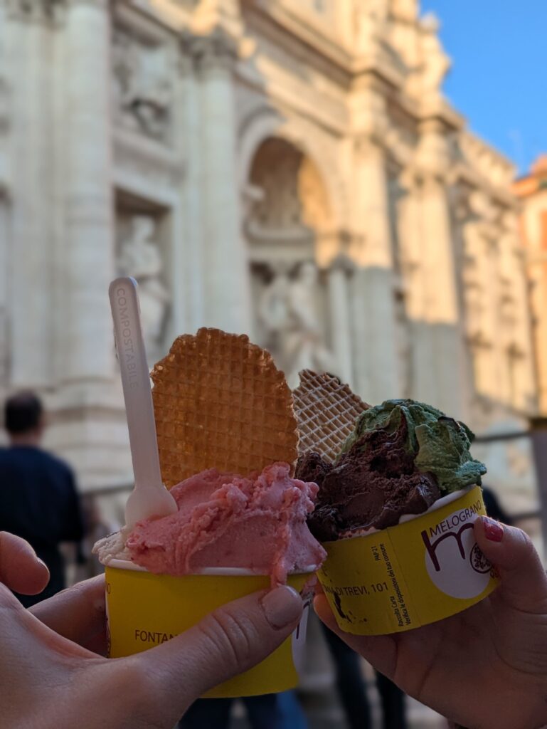 Two cups of gelatos in front of the Trevi Fountain, in Rome, Italy.