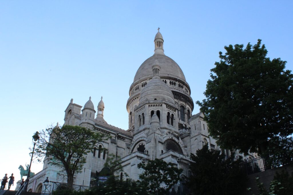Sacré-Coeur Basilica seen from a street below in Montmartre, Paris, France.