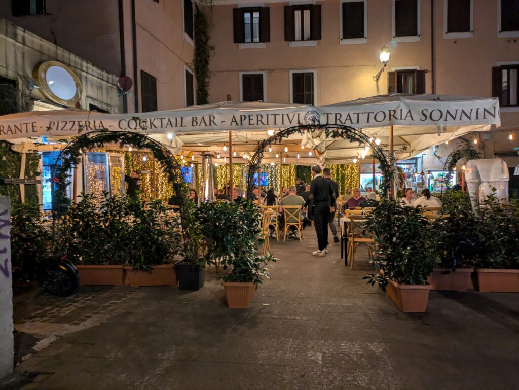 Italian restaurant terrace with cute lights at night in Trastevere, Rome, Italy. Exploring the lovely Trastevere is one of the most fun things to do in Rome with kids.