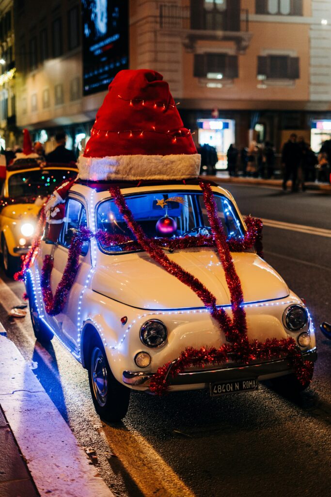 A small white newbeattle car decorated for Christmas in the streets of Rome, Italy.
