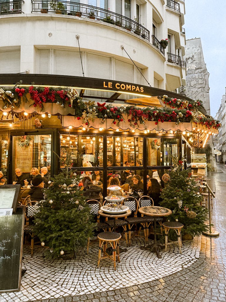 Cozy Paris café Le Compas with festive decorations and bustling atmosphere.