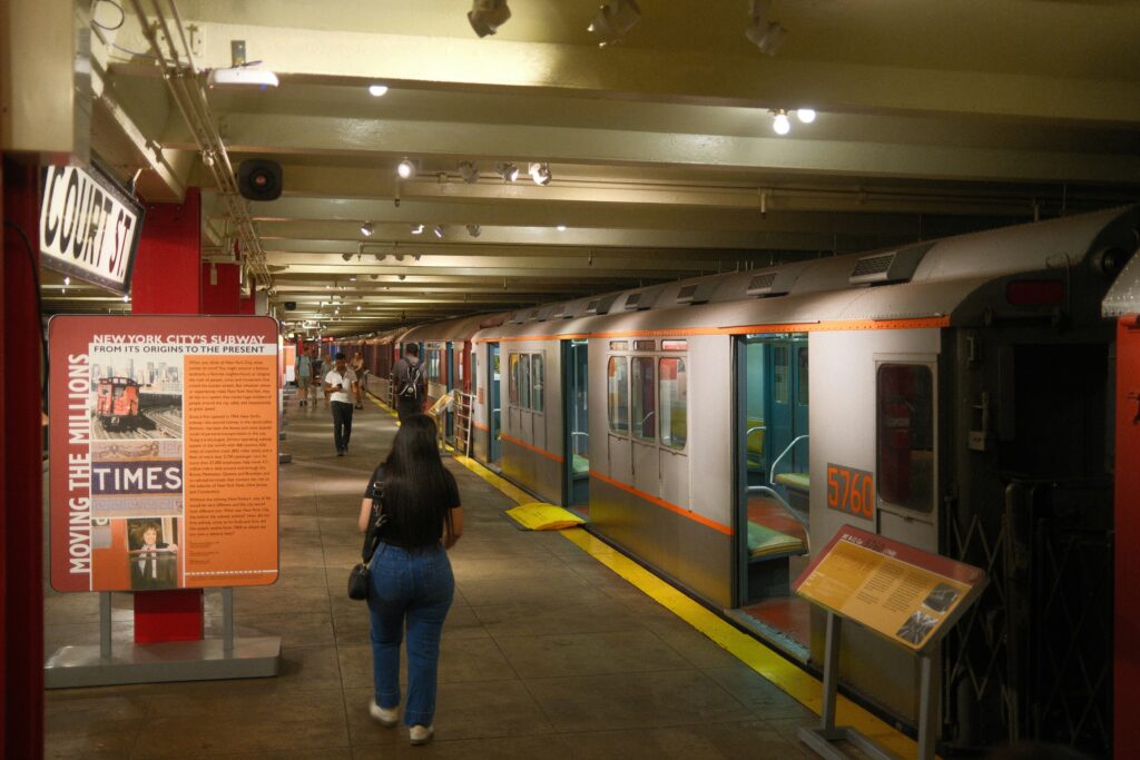 A lady walking near a NYC subway in the New York Transit Museum in Brooklyn.