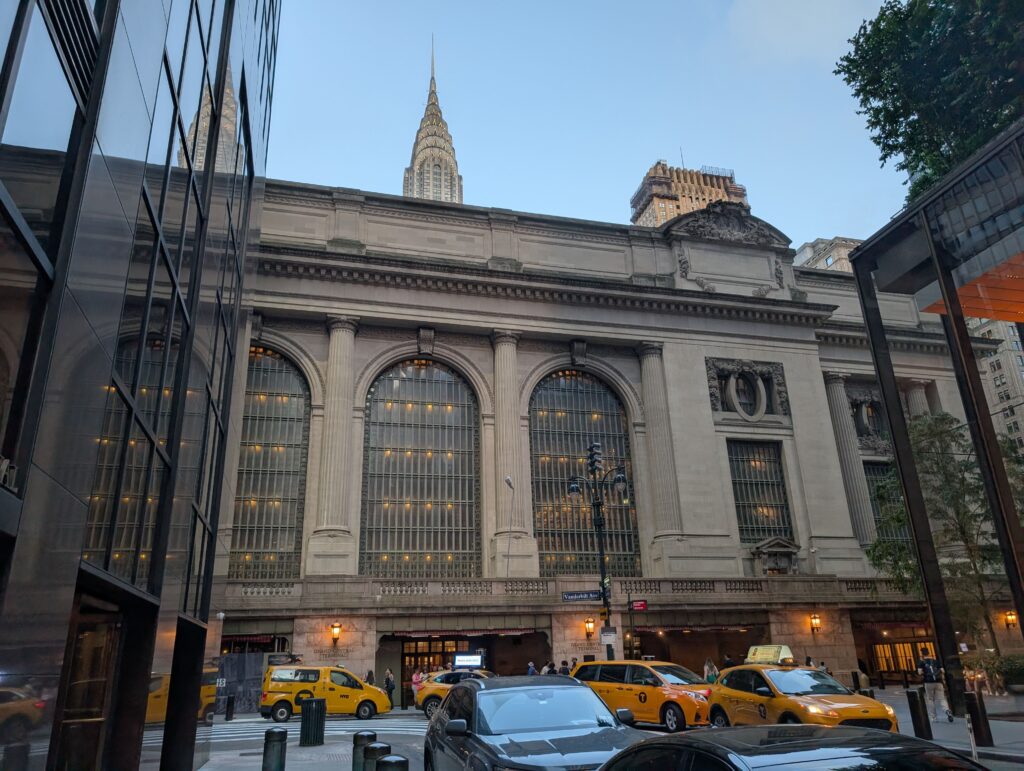 Yellow taxis on the street in front of the Grand Central Terminal in New York City. Taxis and Uber can be a great option to get around NYC with kids after a long day of sightseeing.