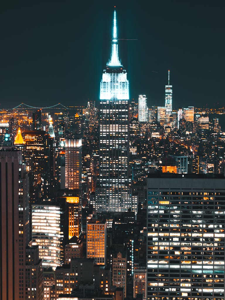 Stunning view of the Empire State Building illuminated amidst the New York City skyline at night.