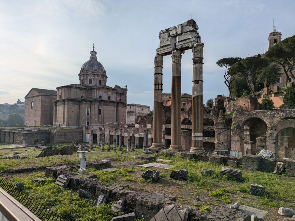 Ancient ruins standing against a sunny sky in Rome, Italy. Walking past those famous ruins is one of the free activities worth adding to your Rome itinerary.